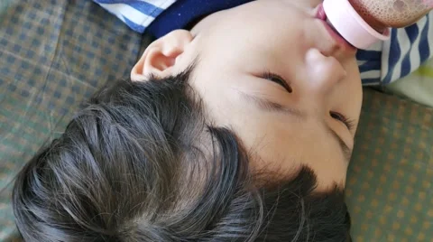 Close up, asian little boy drinking from bottle, 스톡 동영상 56697340
