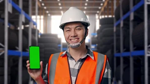 Close Up Of Asian Male Engineer Smiling And Showing Green Screen Smartphone Stock Footage 341787004