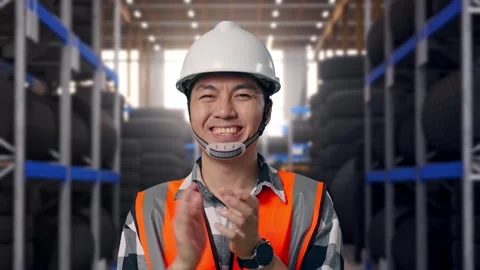 Close Up Of Asian Male Engineer Smiling And Clapping His Hands at Tire Warehouse Stock Footage 341787122