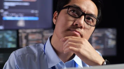 Close Up Of Asian Male Programmer Thinking About Something And Raising Stock Footage 230182070