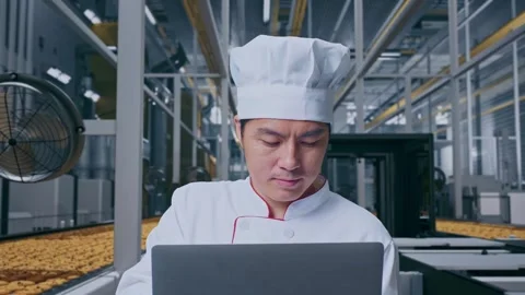Close Up Of Asian Man Chef Using A Laptop In Cookie Factory Stock Footage 318081592