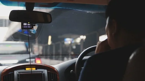 Close up of Asian man driving through traffic congestion in Bangkok, Thailand Stock Footage 107480095
