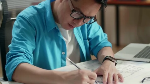 Close Up Of Asian Man Engineer With A Laptop Drawing Blueprint At The Office Stock-Footage 184902351