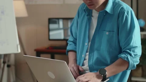 Close Up Of Asian Man Engineer Sitting On The Table And Using A Laptop To Work Stock Footage 184904497