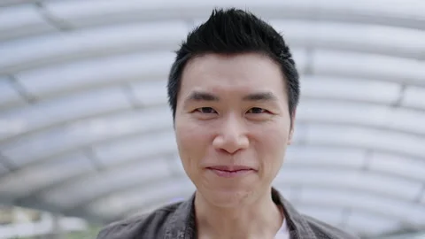Close up of Asian man face is talking or introduce an happy with a smile. Stock Footage 142701805