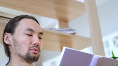 Close-up asian man reading a book Video stock 151850415