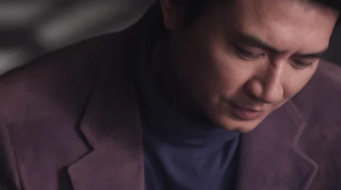 Close up of Asian man smiling &amp; looking up slow motion Stock Footage 30477503