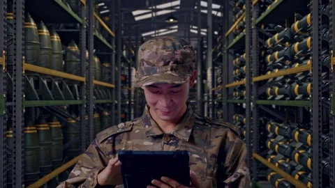 Close Up Of Asian Man Soldier Using A Tablet In Military Storage Stock Footage 313738037