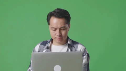 Close Up Of Asian Man Using Laptop Computer While Walking On The Green Screen Stock Footage 248006641