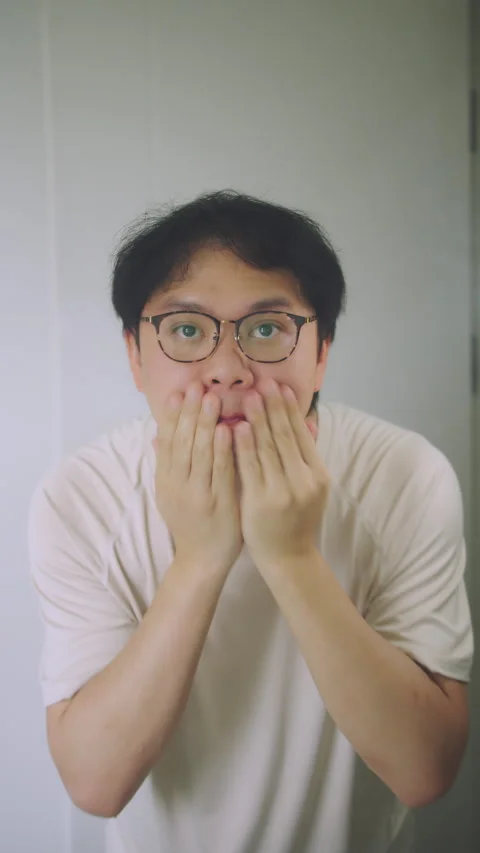 Close-up of Asian Man Washing Face and Checking Skin in Bathroom Mirror, Stock Footage 337769706