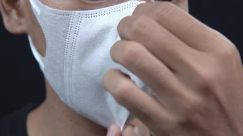 Close up of Asian man wearing white protective face mask for healthcare Stock Footage 345330835