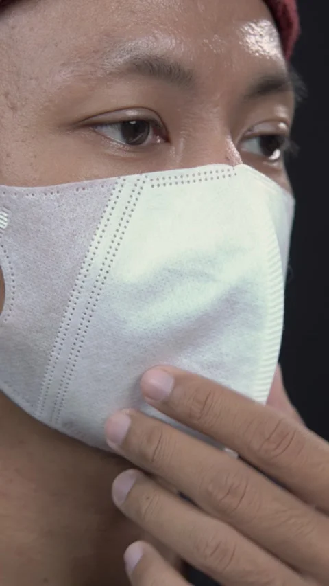 Close up of Asian man wearing white protective face mask for healthcare Stock Footage 345331010