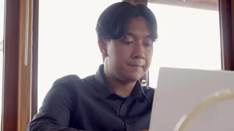 Close up of Asian man working on computer in cafe Stock Footage 310205823