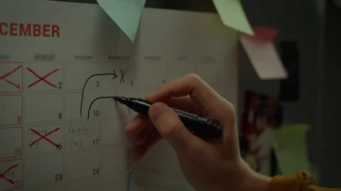 Close up of Asian man's hand writing note in weekly planner with marker. Set Stock Footage 281418828