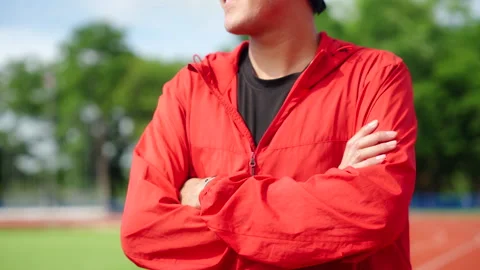 Close up asian runner man standing with arms crossed outdoors. Video stock 248123532