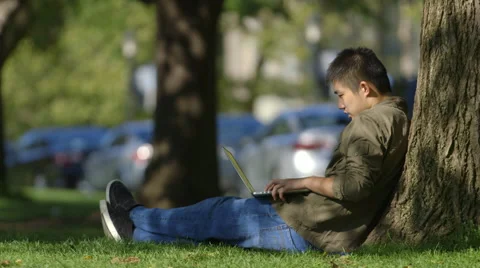 Close up of Asian student working on laptop outdoors Stock Footage 44267206