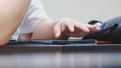 Close up of asian students hand touching the screen of a tablet pc Stock Footage 107613662