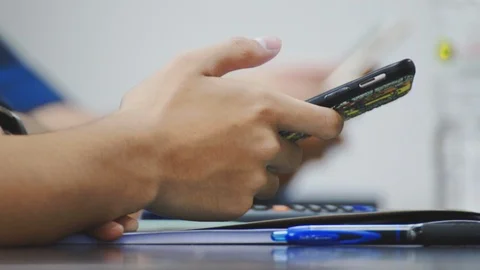 Close up of asian students hand using smartphone in class which distracted them Stock Footage 107613936