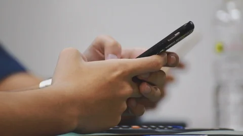Close up of asian students hand using smartphone in class which distracted them Stock Footage 107613974