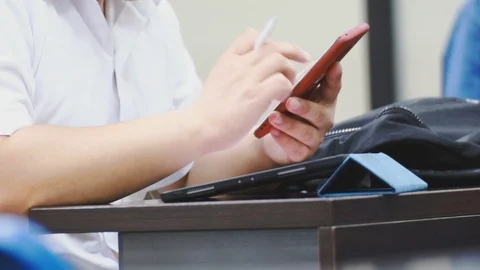 Close up of asian students hand using smartphone in class which distracted them Stock Footage 107614130