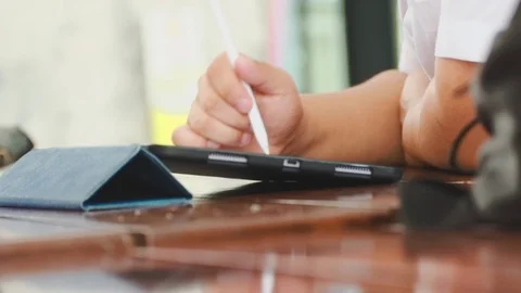 Close up of asian students taking notes during a class on their tablet pc Stock-Footage 107613757