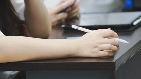 Close up of asian students taking notes during a class on their tablet pc Stock Footage 107613985