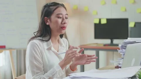 Close Up Of Asian Woman With Documents Explaining Work On Paper While Having Stock Footage 196125417