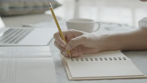Close up of Asian women  taking notes a pencil at home Stock Footage 109389941