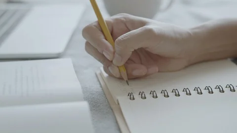 Close up of Asian women taking notes a pencil at home Stock Footage 109500962