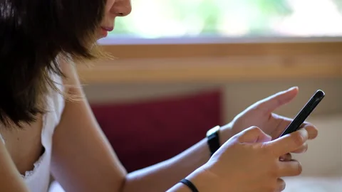 Close up of Asian young lady texting on mobile phone Stock Footage 154880464