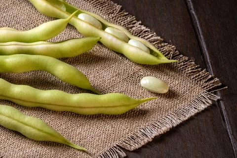 Close-up of asparagus beans on a rustic burlap napkin for culinary presentati Stock Photos