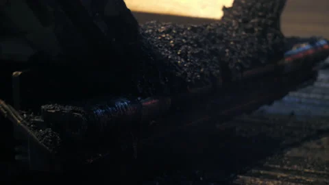 Close-up of an asphalt paver working. Fresh asphalt mix. An asphalt paver is Stock Footage 153768779