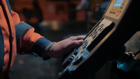 A close-up of the asphalt paver's control panel. Road worker's hand at the Stock Footage 154542668