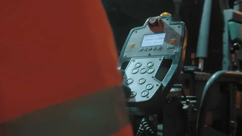 A close-up of the asphalt paver's control panel. Road worker's hand at the 库存影片 155111124
