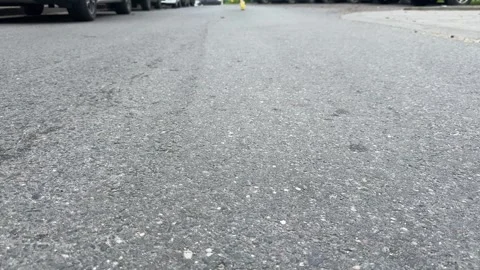 Close-up of asphalt road texture with blurred cars Vídeo Stock 336796626
