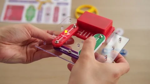 Close-up of assembling simple electronic circuit, educational STEM kit. Basic Stock Footage 346720067