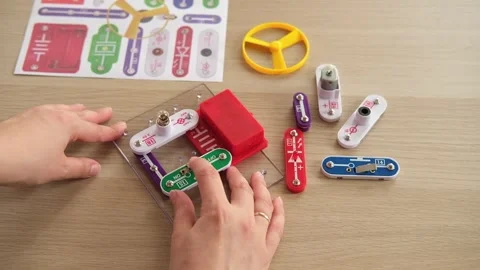 Close-up of assembling simple electronic circuit, educational STEM kit. Basic Stock Footage 346721652