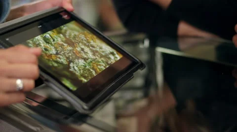Close up of associate at marijuana shop pointing to product on a tablet Stock Footage 58877258