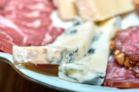 Close-up of assorted cheese and cured meat platter for party appetizers Stock Photos