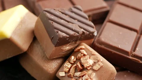 Close up of assorted chocolates and chocolate bar slowly rotating for delig.. Stock Footage 332886440