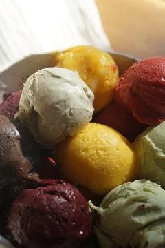 Close up of assorted colorful ice cream and sorbet scoops served in a rusti.. Stock Photos