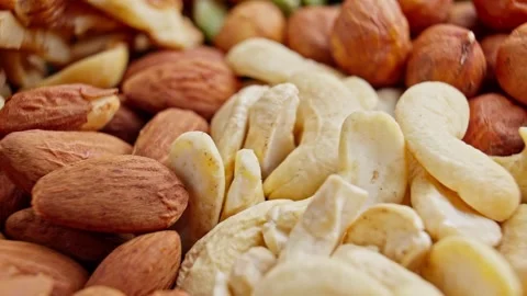 Close-up of assorted dried fruits and nuts rotating. Raw snack. Pile of food Video stock 288012208