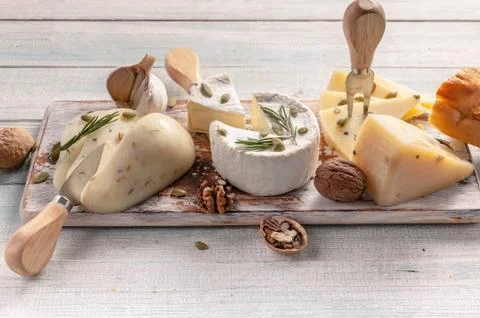 Close Up assorted fresh cheese and nuts on wooden background. Food banner Stock Photos