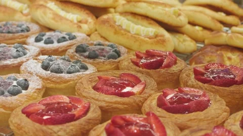 Close-up of assorted freshly baked Danish pastries topped with berries Stock Footage 345967935