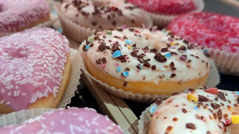 Close-up of Assorted Glazed Donuts with Different Toppings. Stock Footage 304635248
