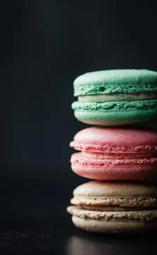 Close up of assorted macaron cookies on black background. 스톡 사진