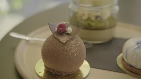 Close-Up of Assorted Plated Desserts in a Sydney Cafe with Soft Natural Lighting Stock Footage 345812157