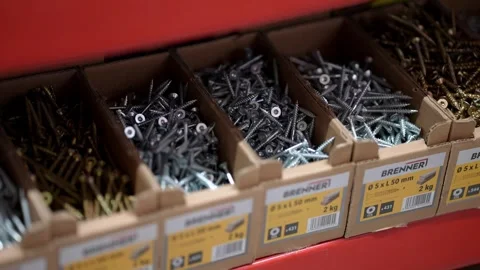 Close Up of Assorted Screws and Fasteners in Cardboard Bins on Red Hardware Stock Footage 332662905
