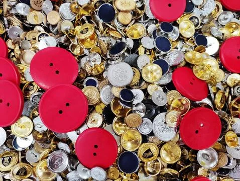 Close-up of assorted sewing buttons arranged in a dense, textured composition Stock Photos