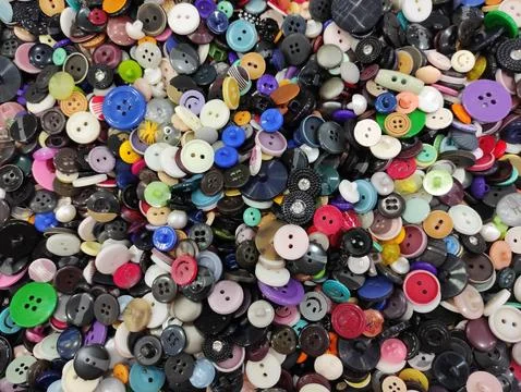 Close-up of assorted sewing buttons arranged in a dense, textured composition Stock Photos